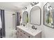 Clean bathroom with a double vanity and arched mirrors at 29840 N 43Rd Way, Cave Creek, AZ 85331