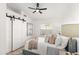 Comfortable bedroom with a ceiling fan and barn door at 29840 N 43Rd Way, Cave Creek, AZ 85331