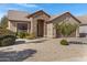 Single-story home with stone accents and a two-car garage at 29874 N Little Leaf Dr, San Tan Valley, AZ 85143