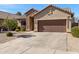 Single-story home with stone accents and a two-car garage at 29874 N Little Leaf Dr, San Tan Valley, AZ 85143