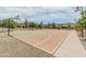Full basketball court in The Bridges at Gilbert community featuring new hoops, benches, and shade trees at 3501 E Apricot Ln, Gilbert, AZ 85298