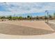 Community basketball court featuring well maintained playing surface, benches, and lighting at 3501 E Apricot Ln, Gilbert, AZ 85298