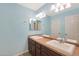 Bathroom with double sinks and light blue walls at 3501 E Apricot Ln, Gilbert, AZ 85298