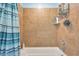 Clean bathroom with shower/tub combo and tiled walls at 3501 E Apricot Ln, Gilbert, AZ 85298