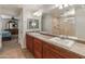 Bathroom boasts dual sinks, wooden cabinetry, and a view into the bedroom at 3501 E Apricot Ln, Gilbert, AZ 85298
