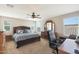 Spacious bedroom with a large bed, dresser, and home office at 3501 E Apricot Ln, Gilbert, AZ 85298