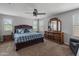 Cozy bedroom featuring a ceiling fan, dresser, and natural light from multiple windows at 3501 E Apricot Ln, Gilbert, AZ 85298