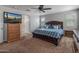 Bright bedroom with a TV, plush carpet, and a glimpse of the connected bathroom at 3501 E Apricot Ln, Gilbert, AZ 85298
