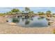 Lush community waterfall and pond surrounded by landscaping in The Bridges at Gilbert neighborhood at 3501 E Apricot Ln, Gilbert, AZ 85298