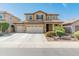 Two-story home featuring a three-car garage, desert landscaping, and a classic-style facade at 3501 E Apricot Ln, Gilbert, AZ 85298