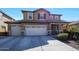 Two-story house with beige exterior, three-car garage, and landscaping at 3501 E Apricot Ln, Gilbert, AZ 85298