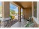 Inviting covered front porch with brick column accents and scenic neighborhood view at 3501 E Apricot Ln, Gilbert, AZ 85298