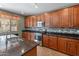 Modern kitchen featuring granite countertops, stainless steel appliances, and a sleek gas cooktop at 3501 E Apricot Ln, Gilbert, AZ 85298