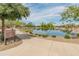 Scenic lake park with walking path, lush landscaping, and serene water views at 3501 E Apricot Ln, Gilbert, AZ 85298