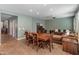 Cozy living room featuring a dining table, comfortable sofa and modern entertainment center at 3501 E Apricot Ln, Gilbert, AZ 85298