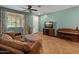 Comfortable living room featuring a TV, piano, tile flooring and a large window at 3501 E Apricot Ln, Gilbert, AZ 85298