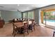 Relaxing living area with a dining table, cozy sofa and a view of the outdoor pool at 3501 E Apricot Ln, Gilbert, AZ 85298