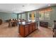 Open concept living and kitchen area with a granite kitchen island, dining table and cozy seating at 3501 E Apricot Ln, Gilbert, AZ 85298