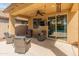 Inviting covered patio with cozy seating and a view of the sparkling pool at 3501 E Apricot Ln, Gilbert, AZ 85298