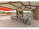 Shaded picnic area near playground with multiple tables for community gatherings in The Bridges at Gilbert at 3501 E Apricot Ln, Gilbert, AZ 85298
