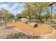 Wood-chip play area with fun features for in a well-maintained community park at 3501 E Apricot Ln, Gilbert, AZ 85298