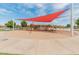 Well-maintained playground with shade canopies in The Bridges at Gilbert community featuring swings and climbing structures at 3501 E Apricot Ln, Gilbert, AZ 85298