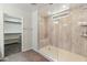 Walk-in shower with a built-in bench, rainfall shower head, and an open door to a closet at 3501 E Apricot Ln, Gilbert, AZ 85298