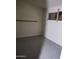 Empty basement room with grey flooring and a window at 3510 W Seldon Ln, Phoenix, AZ 85051