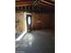 Unfinished garage interior with exposed beams and a door at 3510 W Seldon Ln, Phoenix, AZ 85051