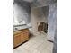 Kitchen needing renovation with exposed plumbing and damaged walls at 3510 W Seldon Ln, Phoenix, AZ 85051