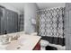 Bathroom with single sink, toilet, and patterned shower curtain at 3621 W Glass Ln, Phoenix, AZ 85041