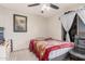 Bedroom with a leopard print comforter and a ceiling fan at 3621 W Glass Ln, Phoenix, AZ 85041