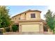 Two-story house with tan exterior, attached garage, and landscaping at 3621 W Glass Ln, Phoenix, AZ 85041