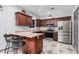 L-shaped kitchen with dark wood cabinets and stainless steel appliances at 3621 W Glass Ln, Phoenix, AZ 85041