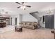 Living room with tile floors, couch, and view of kitchen at 3621 W Glass Ln, Phoenix, AZ 85041