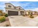 Two-story house with a brown garage door and nicely landscaped front yard at 36582 N Lincoln Red Rd, San Tan Valley, AZ 85143