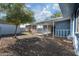 Landscaped backyard with gravel, a tree, and covered patio at 3707 W Encanto Blvd, Phoenix, AZ 85009