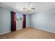 Simple bedroom with tiled floors and a window with curtains at 3707 W Encanto Blvd, Phoenix, AZ 85009