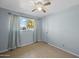 Simple bedroom with tiled floors and window with curtains at 3707 W Encanto Blvd, Phoenix, AZ 85009