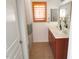 Bright bathroom with double sinks, tiled floor, and window with plantation shutters at 3919 E Blue Sage Rd, Gilbert, AZ 85297