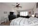 Main bedroom with hardwood floors, ceiling fan, and a relaxing sitting area at 4741 S Desert Dawn Dr, Gold Canyon, AZ 85118