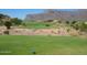 Golf course with distant homes and mountains at 4741 S Desert Dawn Dr, Gold Canyon, AZ 85118