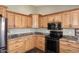 Modern kitchen with stainless steel appliances and wood cabinets at 4741 S Desert Dawn Dr, Gold Canyon, AZ 85118