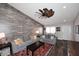 Living room with gray couches, wood-look floors, and a rustic accent wall at 4741 S Desert Dawn Dr, Gold Canyon, AZ 85118