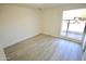 Bright bedroom with wood-look floors and large window at 4901 W Cheery Lynn Rd, Phoenix, AZ 85031