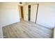 Simple bedroom with light wood flooring and a closet at 4901 W Cheery Lynn Rd, Phoenix, AZ 85031