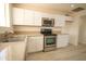 Bright kitchen with white cabinets, granite countertops, and stainless steel appliances at 4901 W Cheery Lynn Rd, Phoenix, AZ 85031