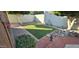 Landscaped backyard with artificial turf and brick walkways at 5124 W Onyx Ave, Glendale, AZ 85302