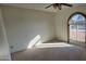 Bright bedroom with carpeted floor and arched window at 5124 W Onyx Ave, Glendale, AZ 85302