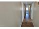 Long hallway with tile flooring leading to bedrooms at 5124 W Onyx Ave, Glendale, AZ 85302